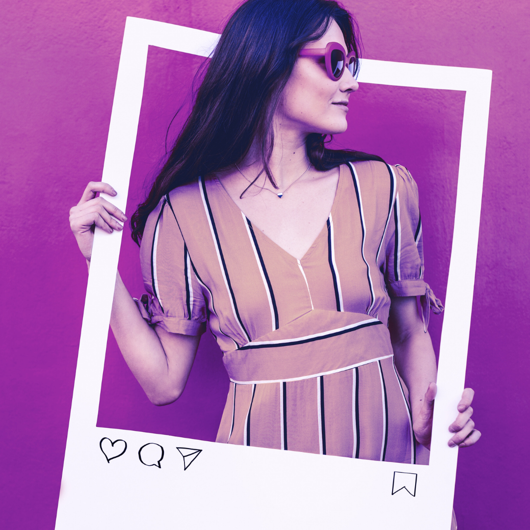 Woman holding an oversized Socially Inclined VIP Services - Pro picture frame against a purple background, perfect for social media marketing.